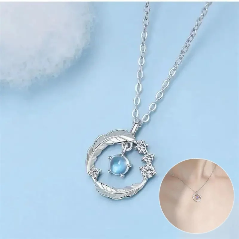 Feather‑shaped silver‑plated pendant necklace with round moonstone bead