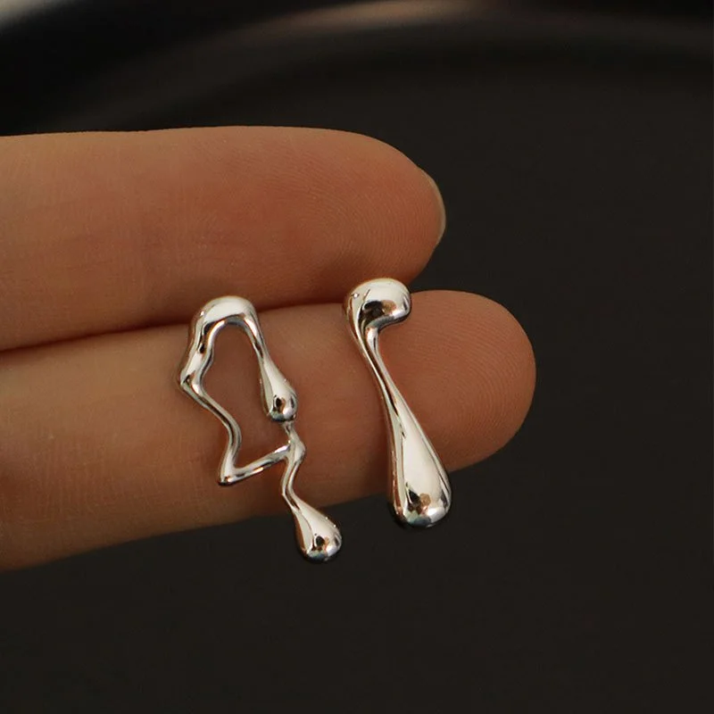 Silver asymmetric geometric earrings with lava-inspired design