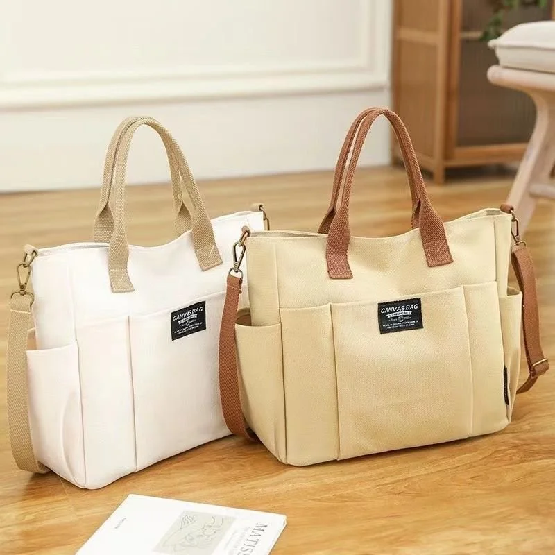 Large capacity shoulder canvas bag with 3‑dimensional pocket for laptop and documents