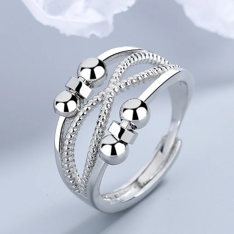 Rotatable platinum‑colored copper ring with double‑layer hollow geometry