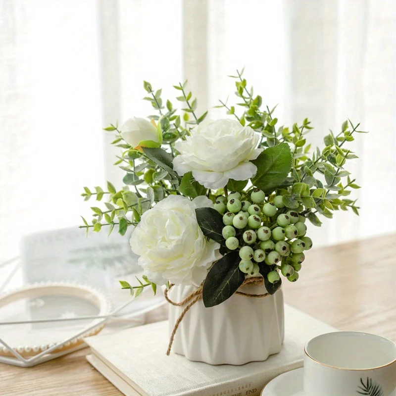 White artificial rose and eucalyptus bouquet in ceramic vase for home decor