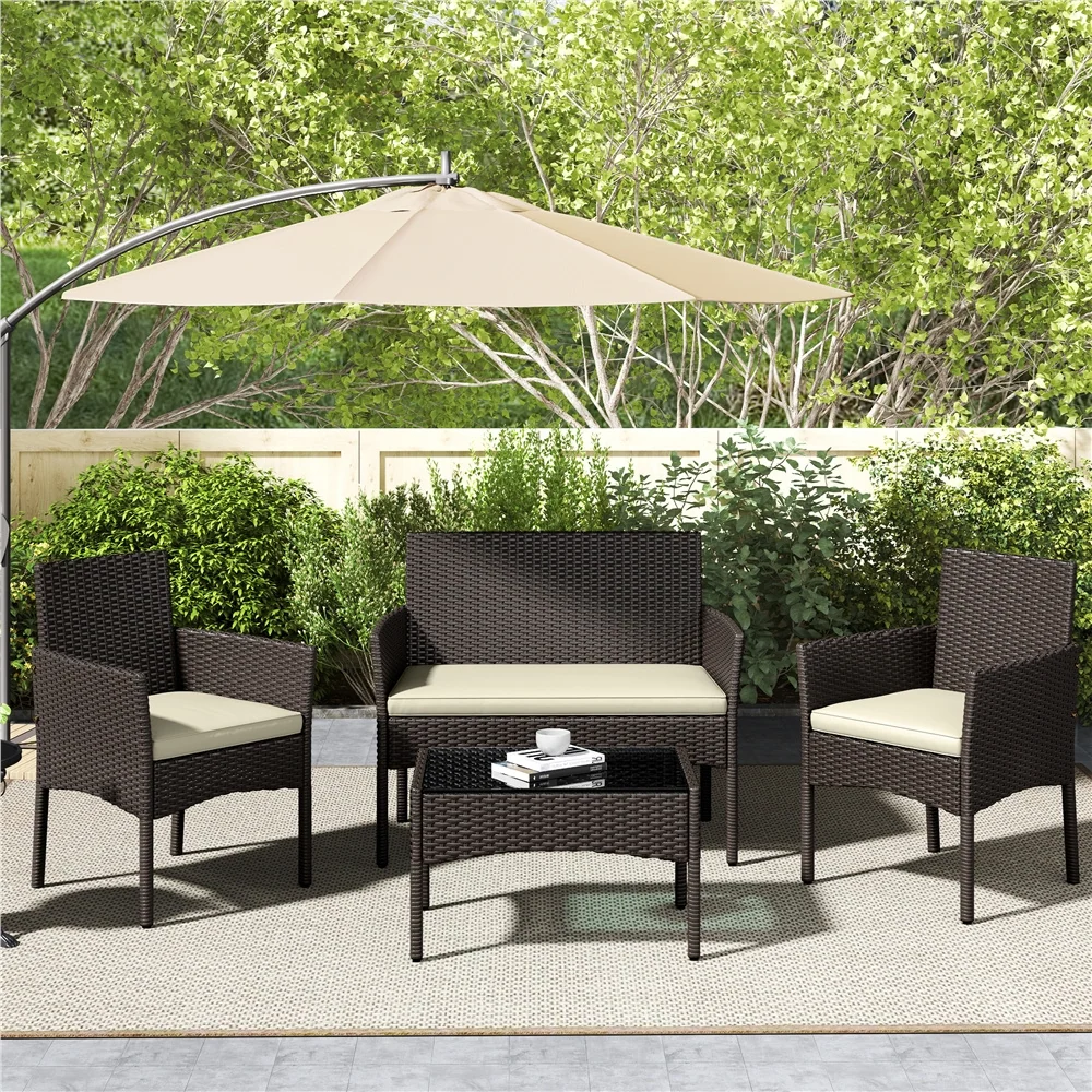 4-piece rattan conversation set with cushioned chairs and glass table