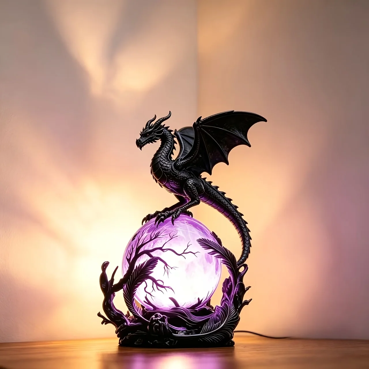 Obsidian dragon statue with luminous sphere for décor