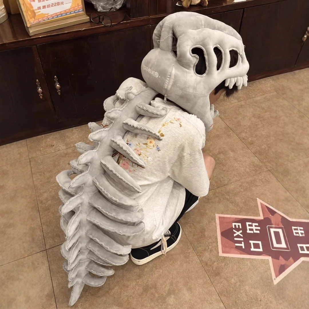 Adult dinosaur costume with skeleton headpiece and plush skull