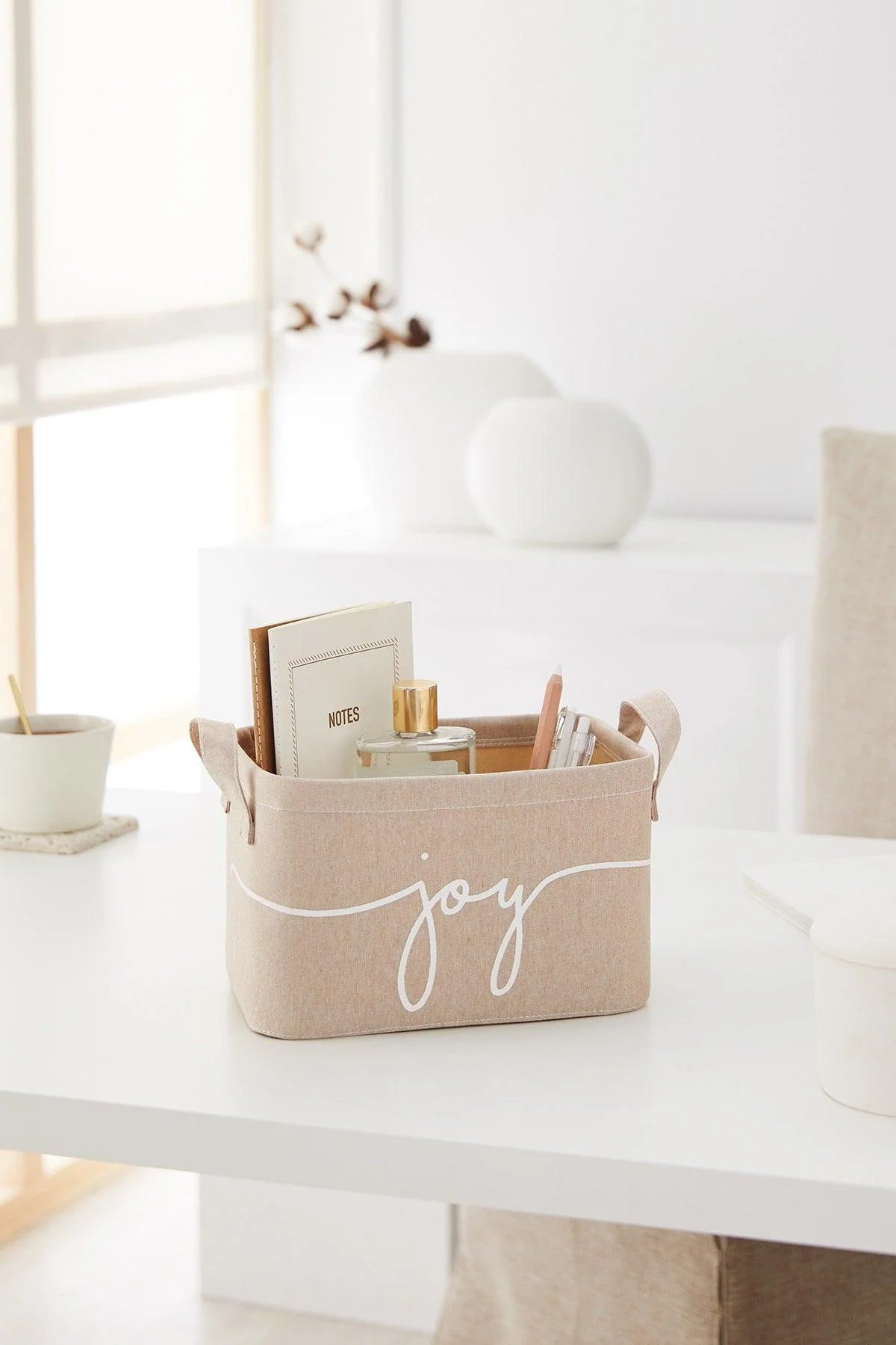 Beige fabric storage basket with handles for closet or shelf organization