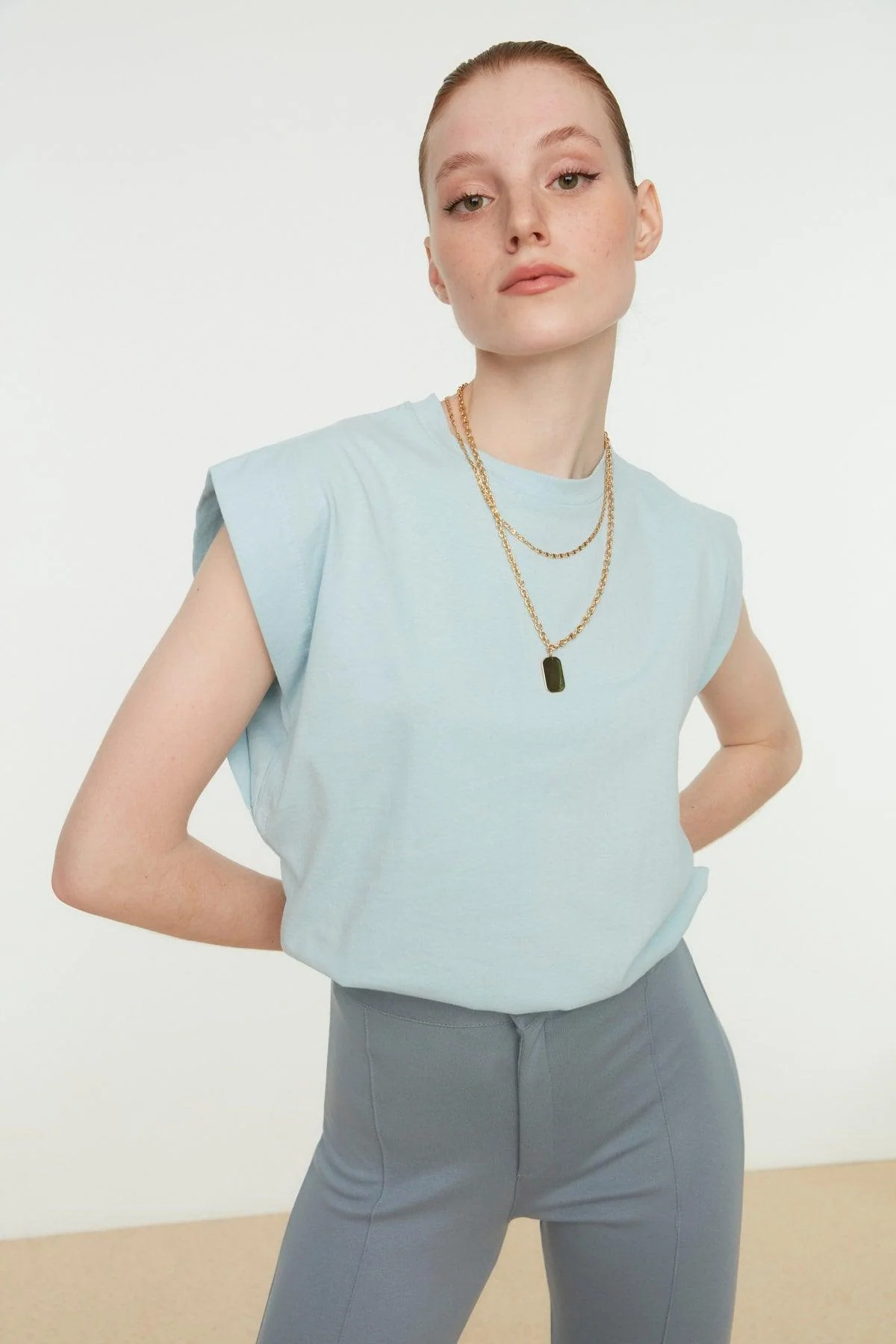 Sleeveless knitted T-shirt in light blue cotton