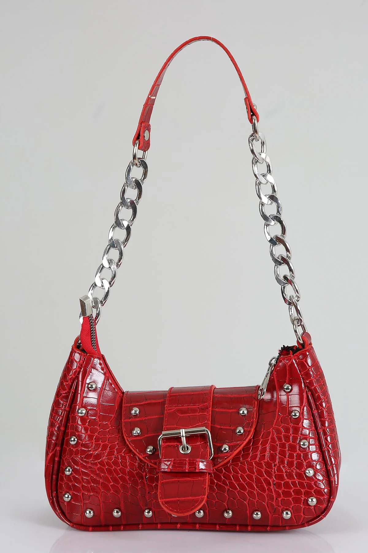 Red crocodile-patterned handle bag with metallic staples and dust bag