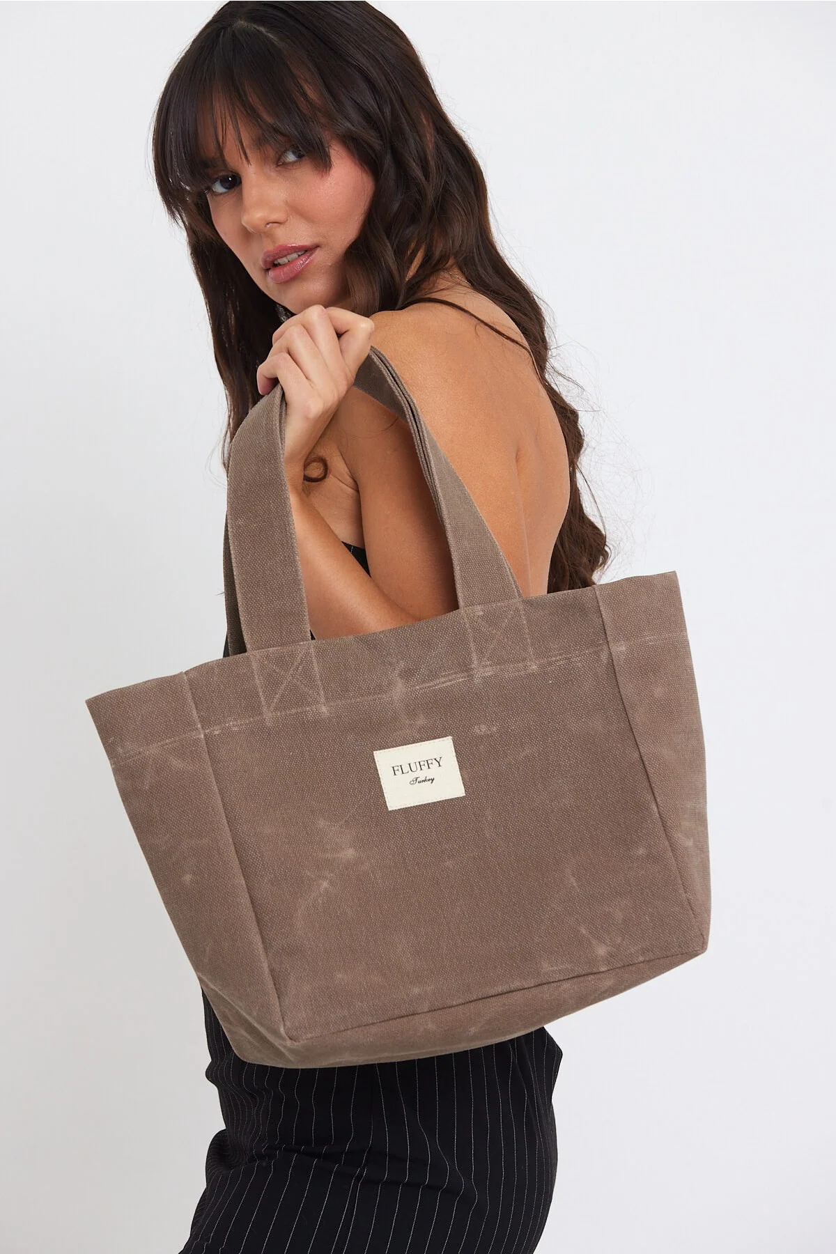 Waxed canvas tote bag with laptop compartment and adjustable handle