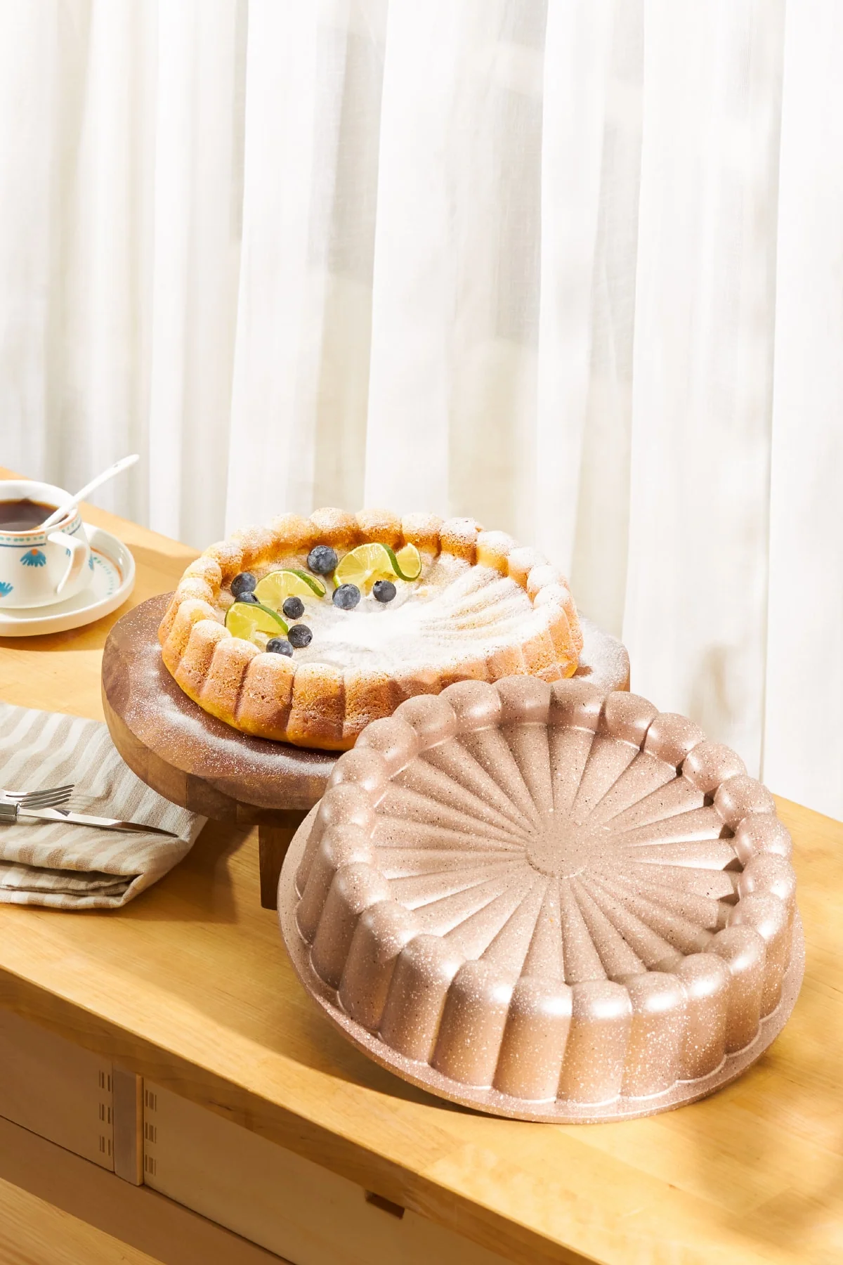 Gold-toned granite cake mold with daisy pattern