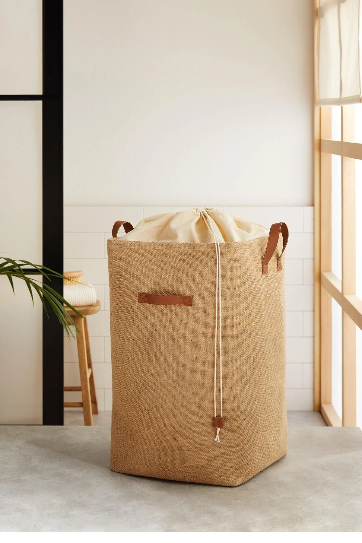 Jute drawstring laundry basket with natural fiber design