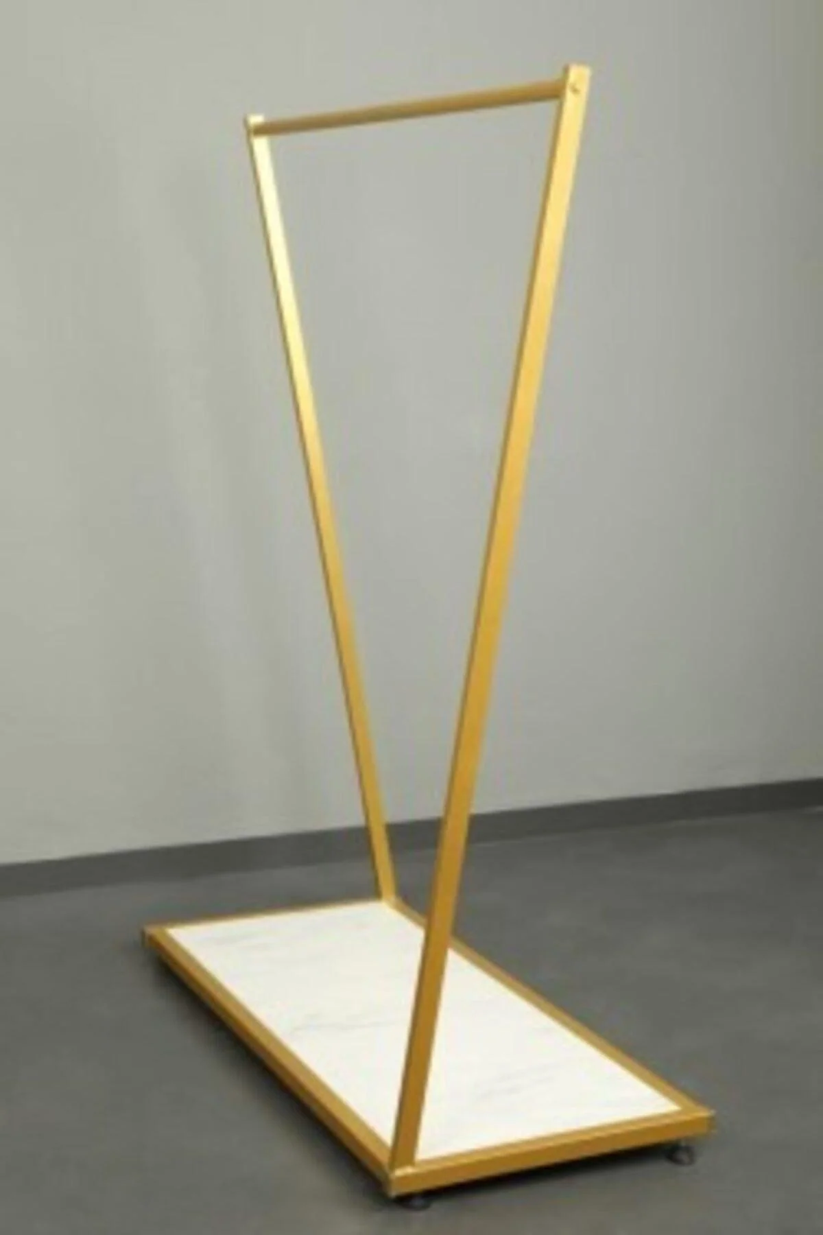 Gold cross-legged standing shelf unit with chipboard shelf