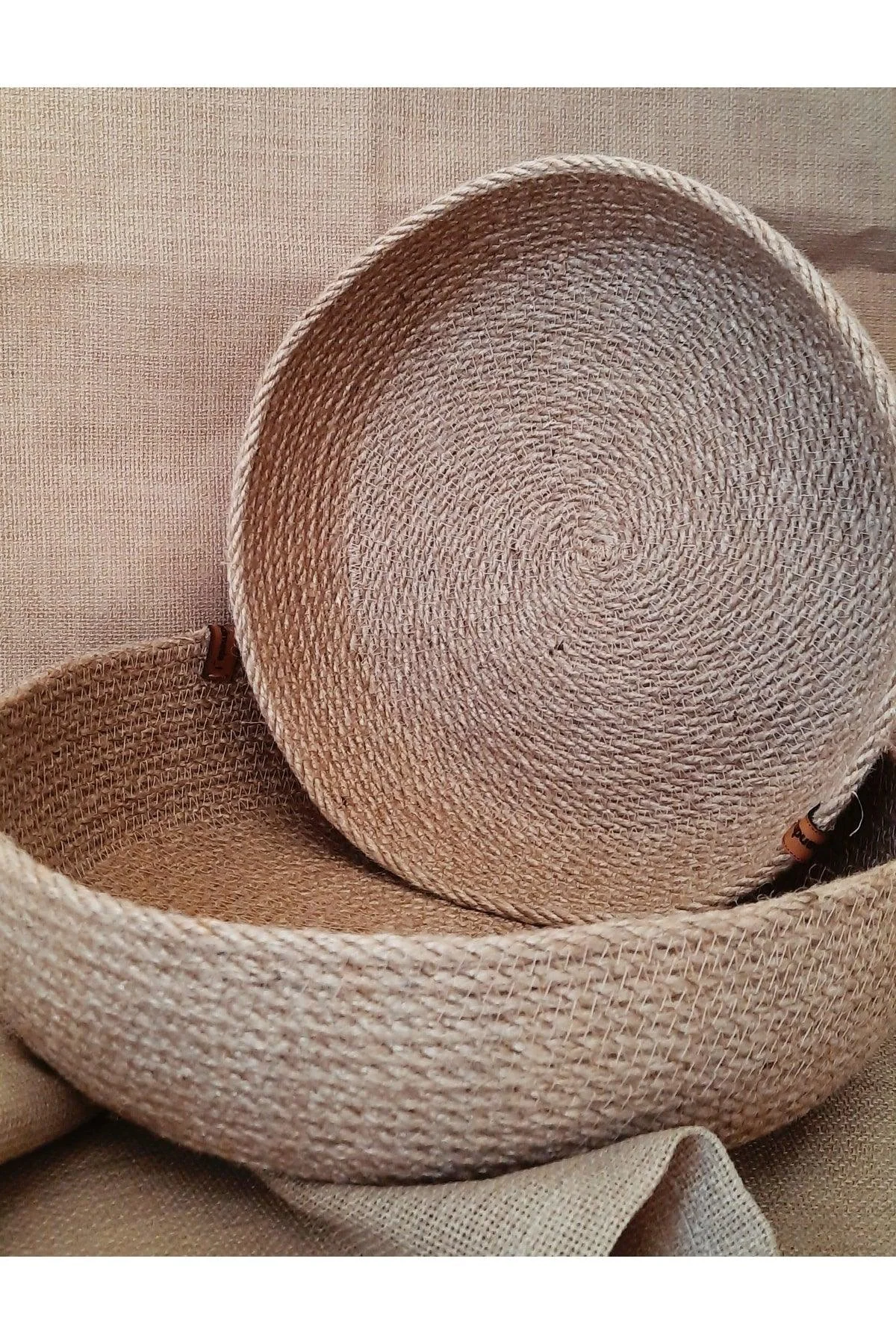 Set of two woven jute and wicker baskets with stylish handles