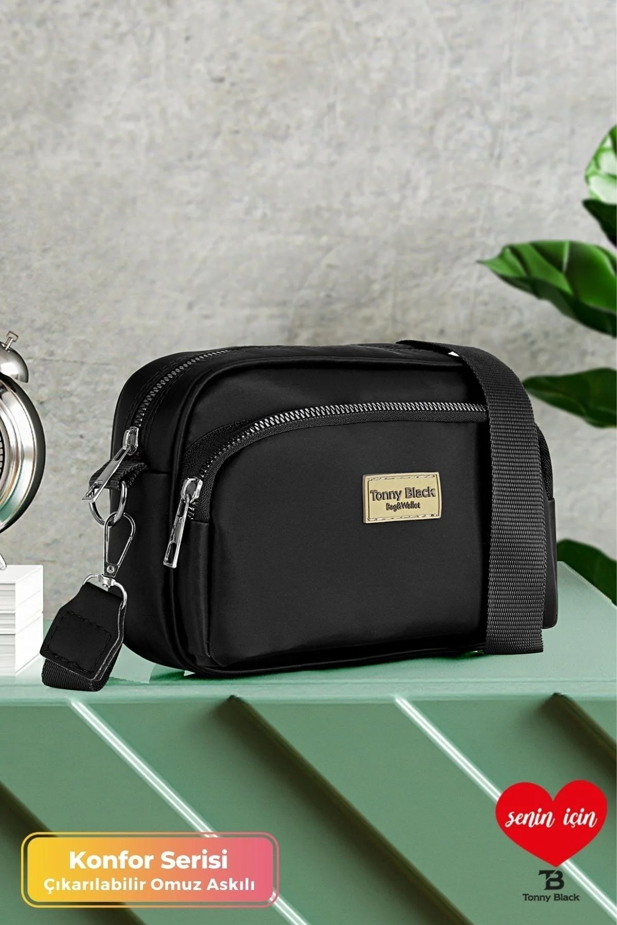 Black mini crossbody bag with adjustable strap and two zippered compartments