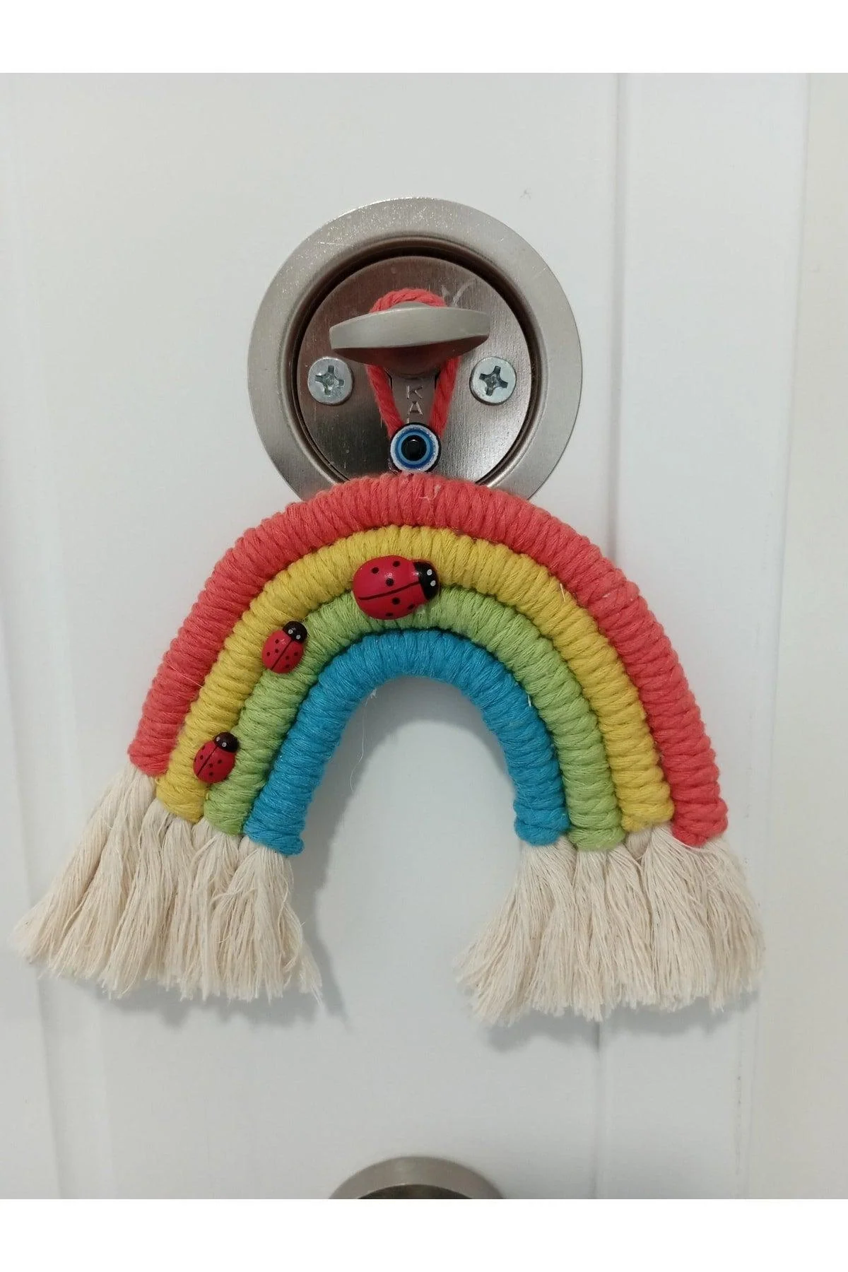 Rainbow macramé wall decoration with ladybug accent 14 cm height
