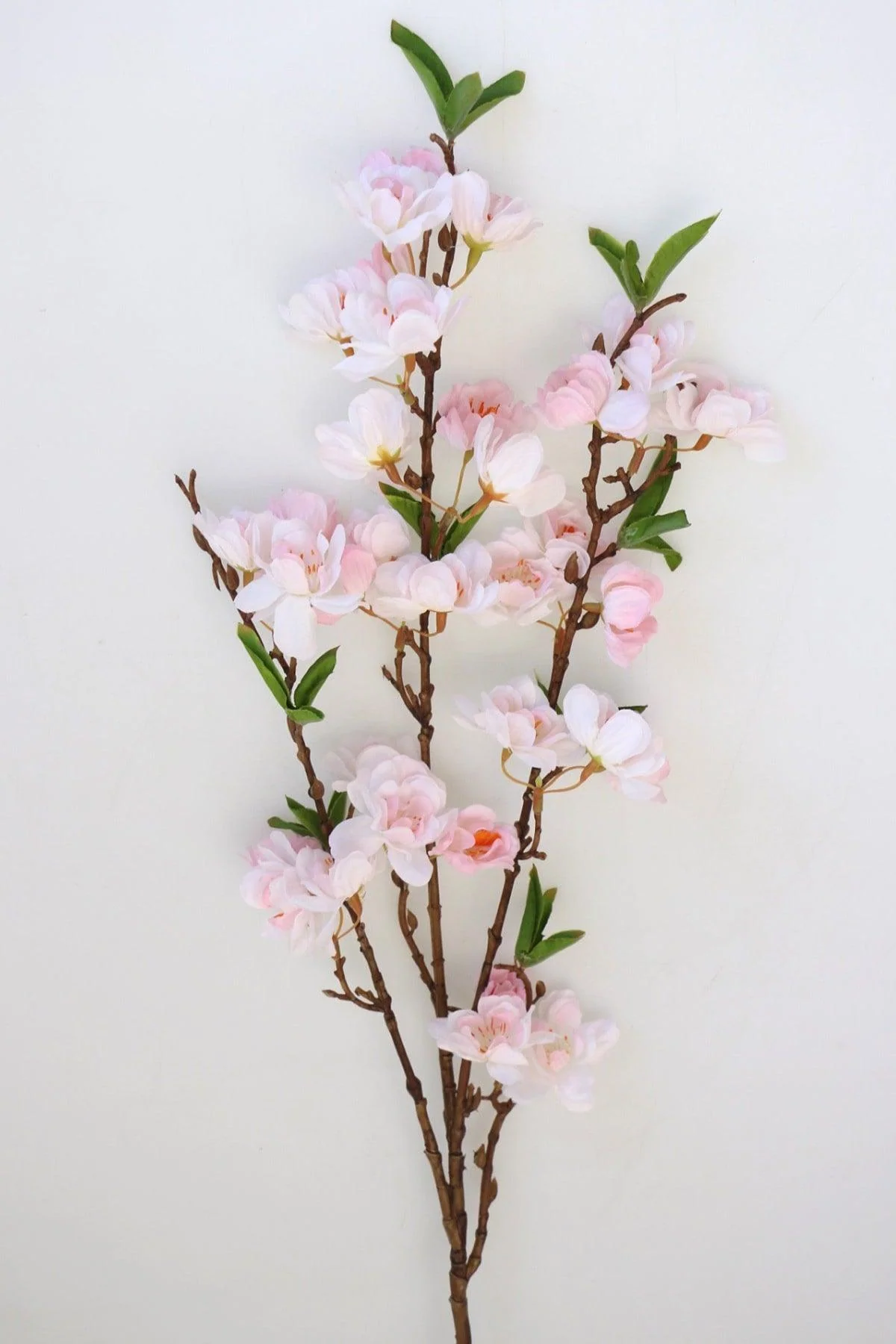 Light pink spring branch with artificial knots 90 cm
