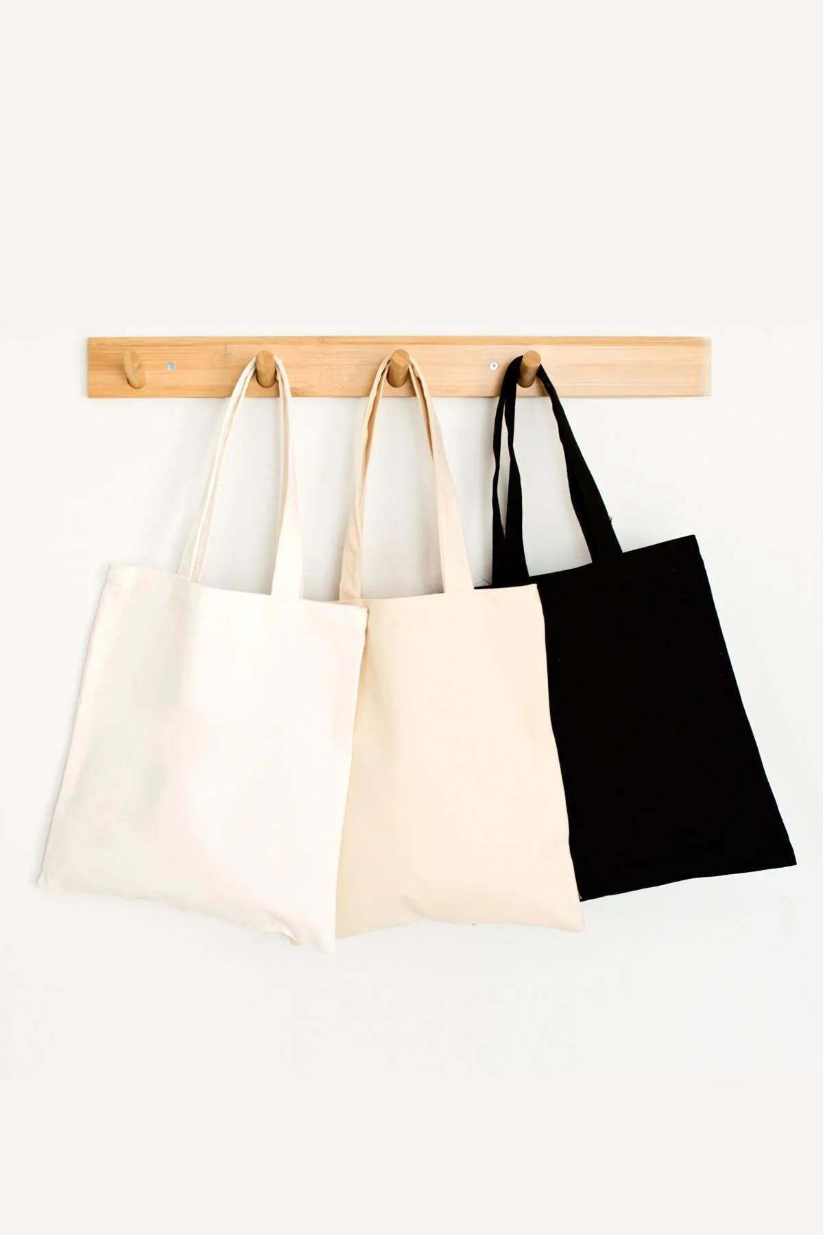 Black, white, and cream colored tote bag with natural fabric