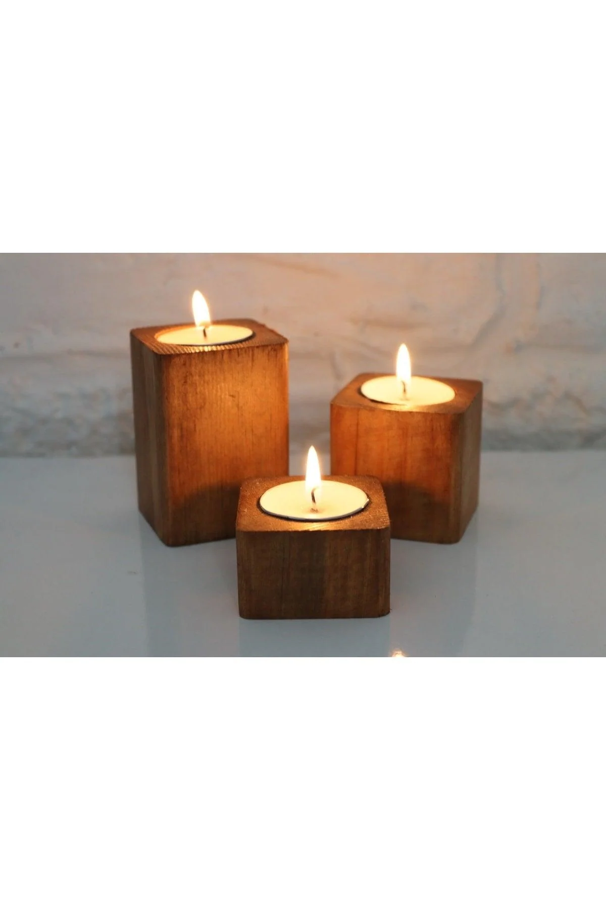 Set of three rustic wooden log candle holders in assorted sizes