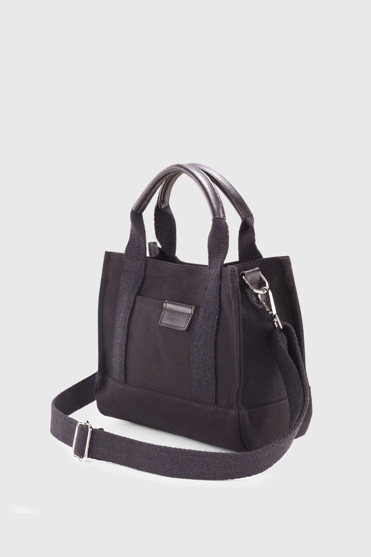 Black canvas tote bag with polyester lining and adjustable strap