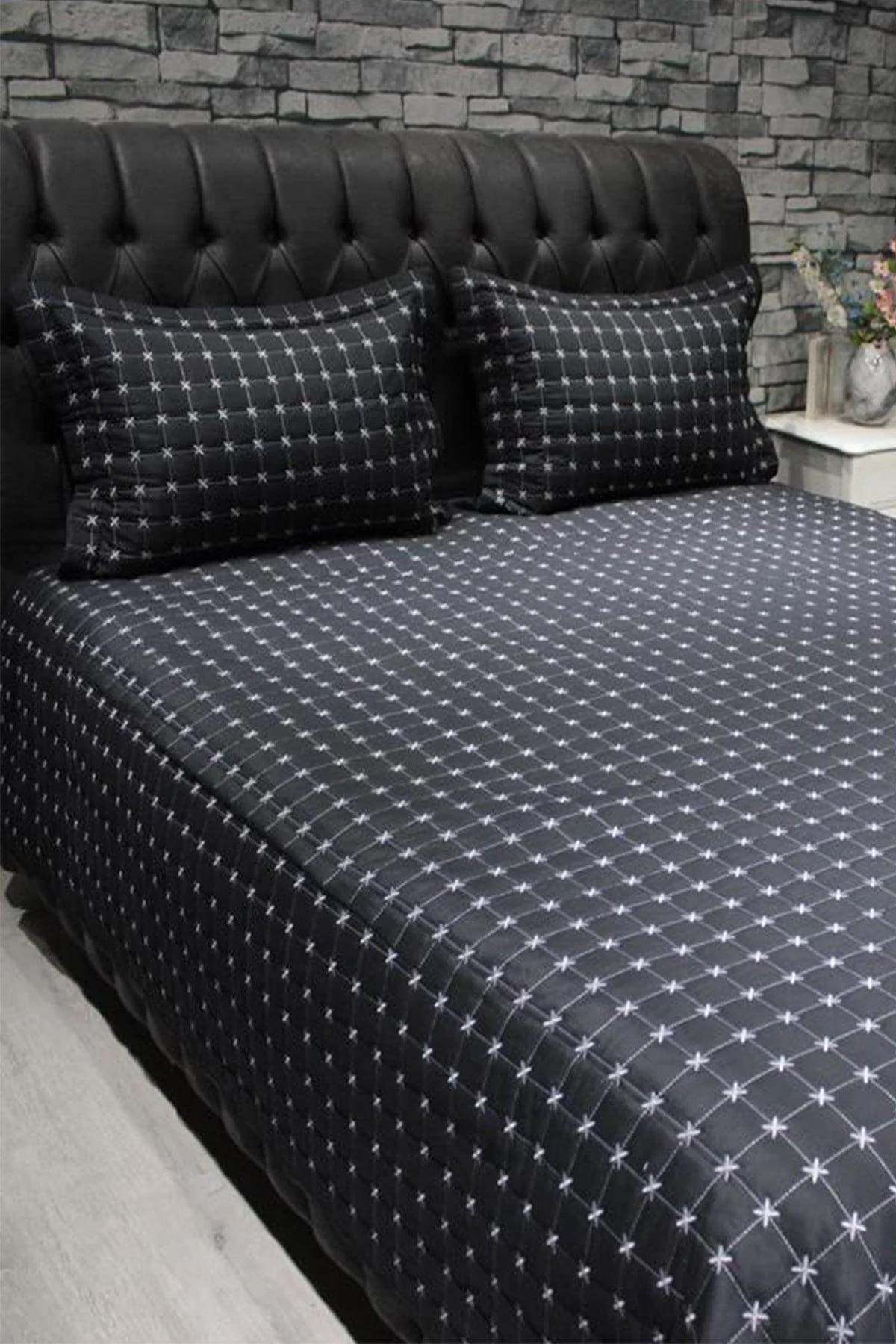 Black quilted double bedspread with pillow covers